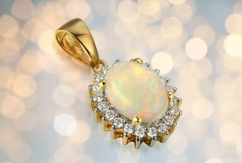 Opal and diamond pendant image with lights in the background.